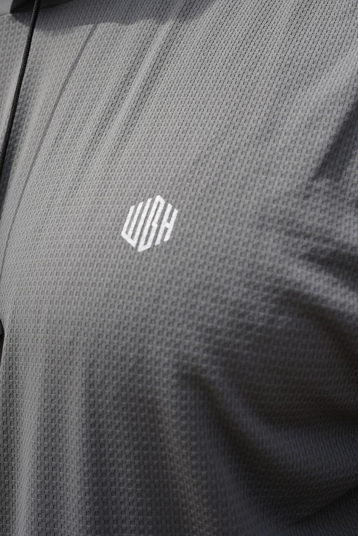Close view of the reflective WGH chest monogram and performance fabric